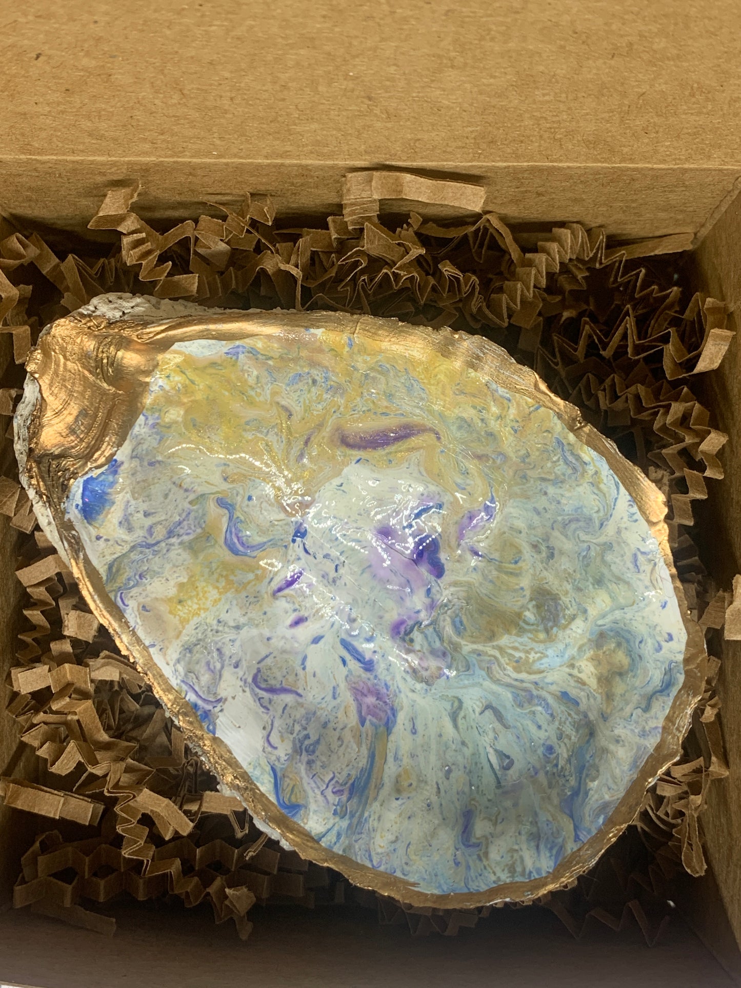 Paint pour in blues, white, and gold jewelry dish